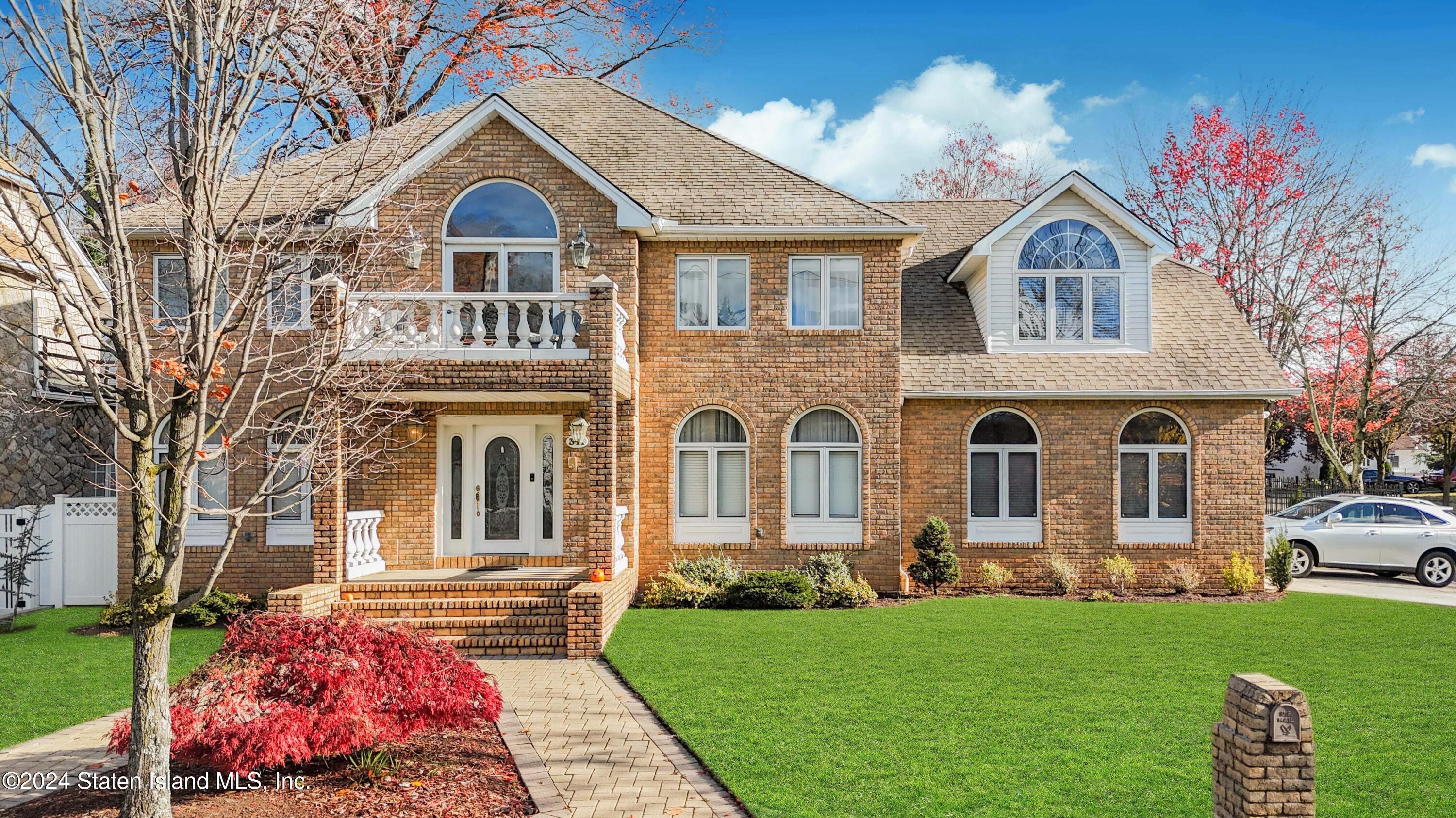 a front view of a house with a garden