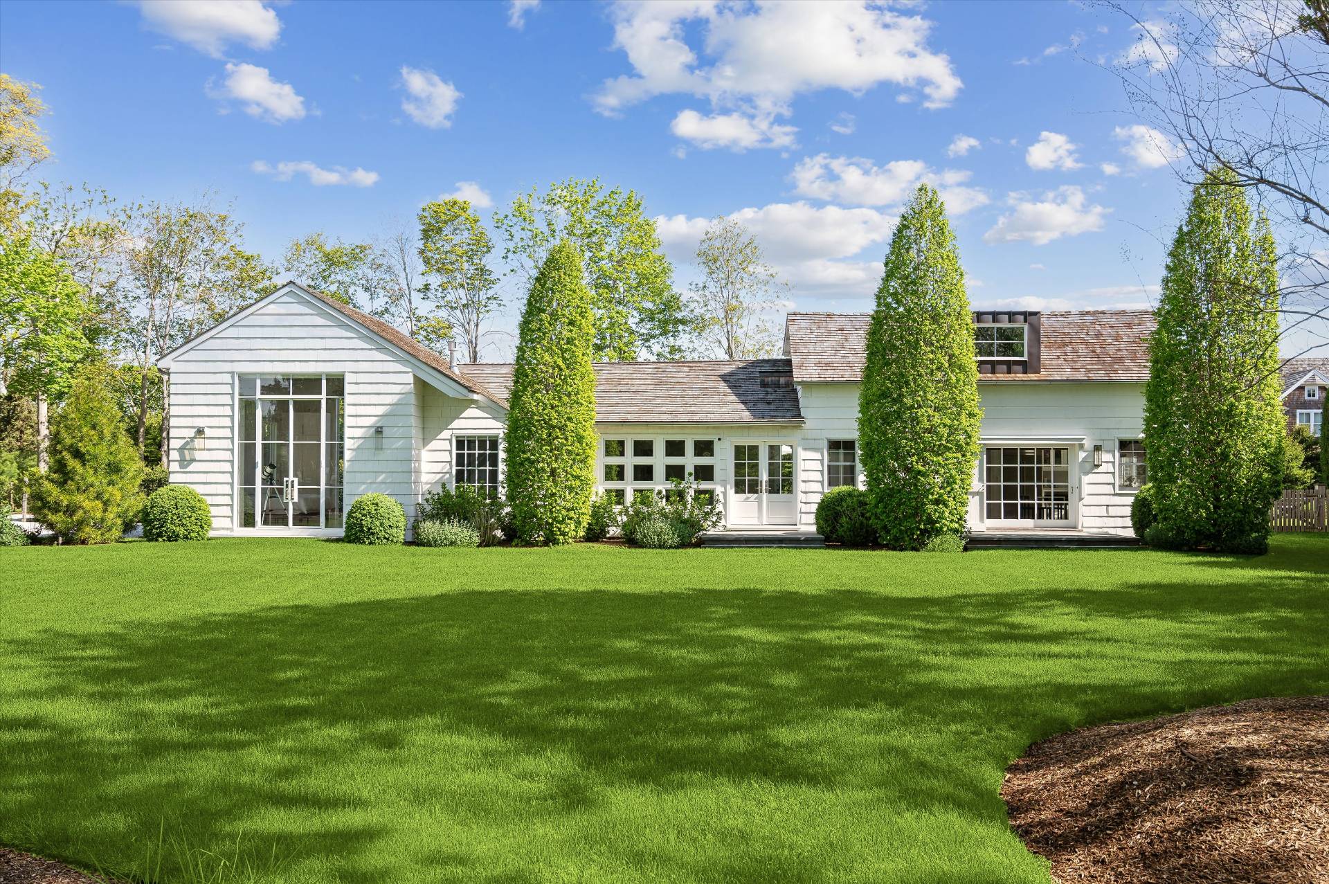 a front view of a house with a garden