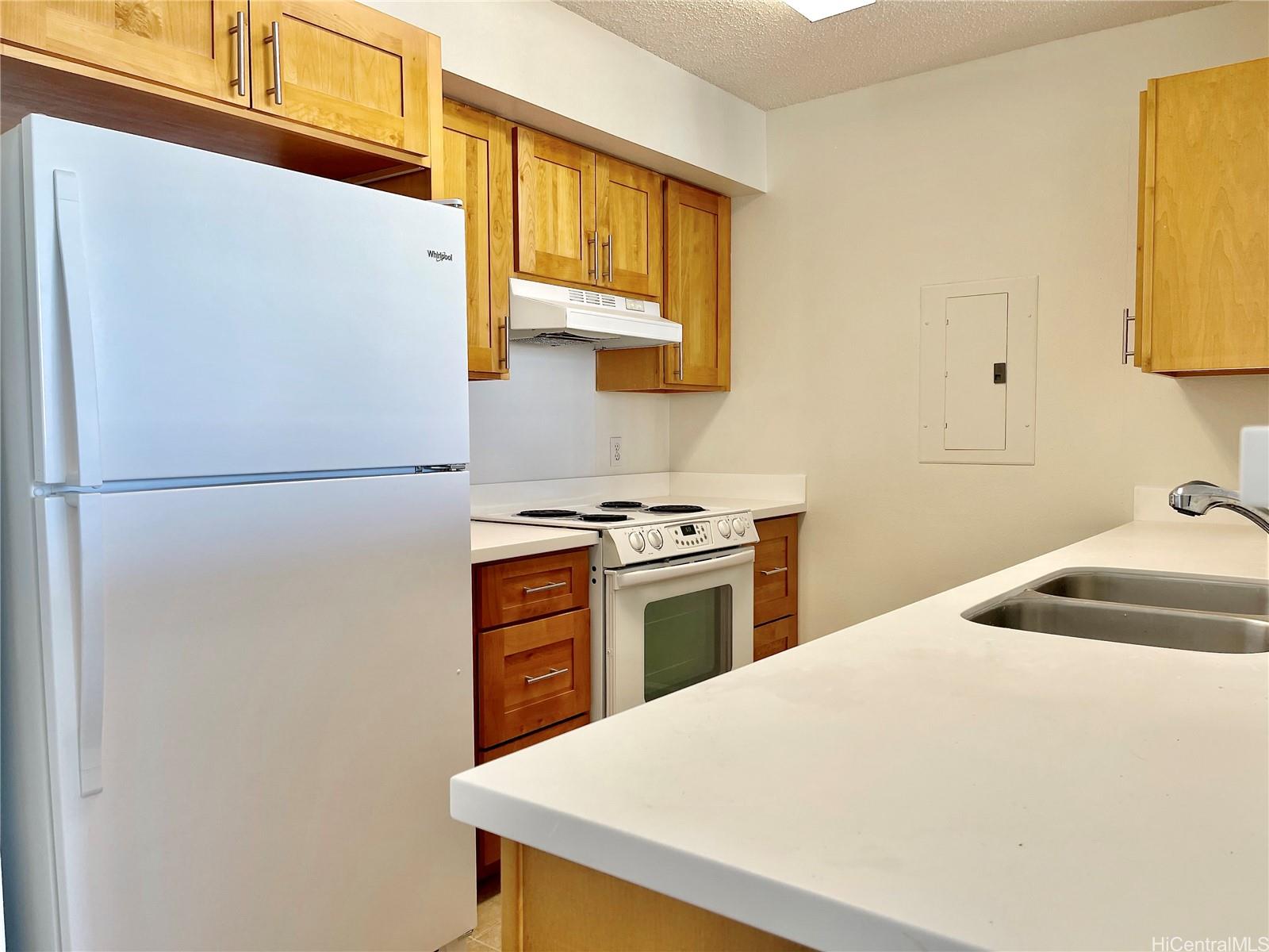 a kitchen with stainless steel appliances a refrigerator sink and white cabinets