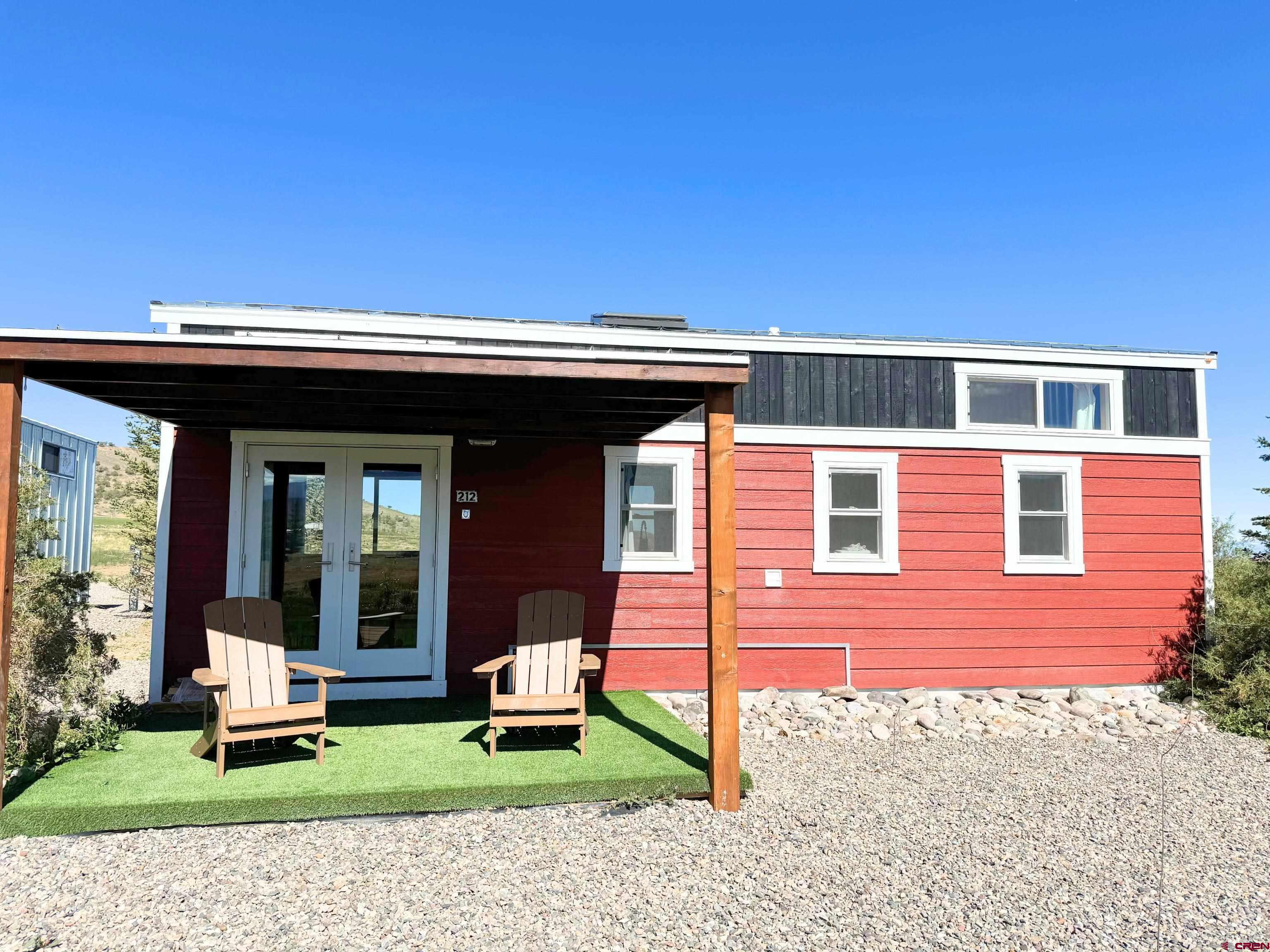 a view of a house with a yard and sitting area