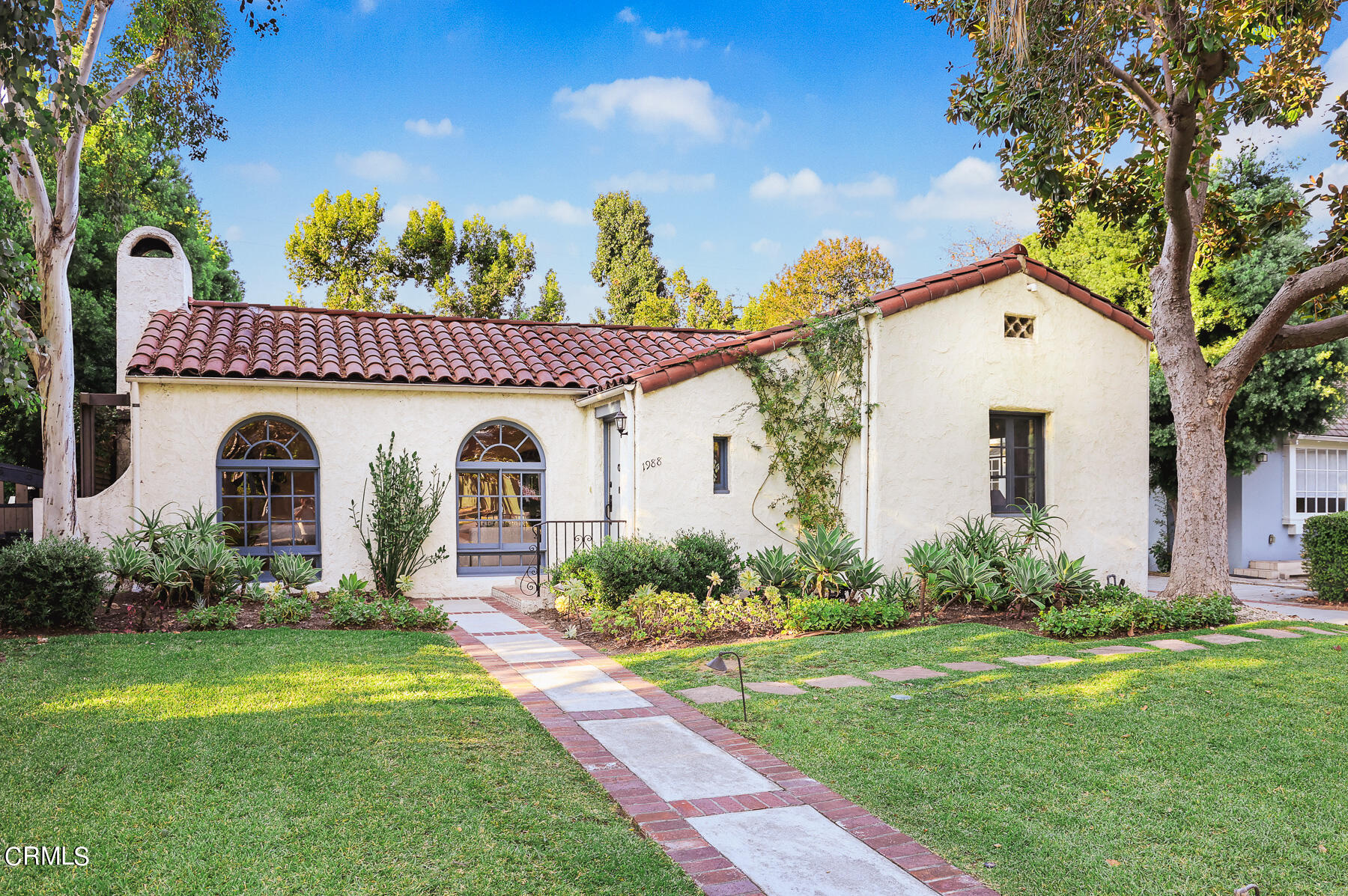 a front view of a house with garden