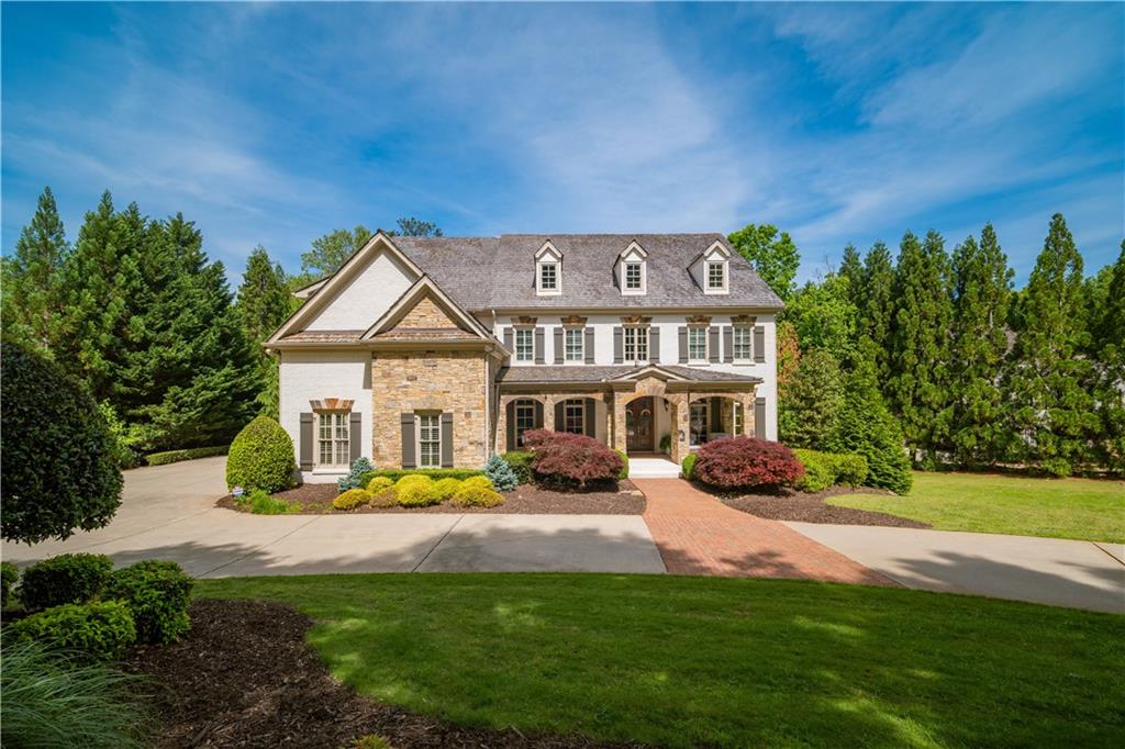 a view of house with yard and green space