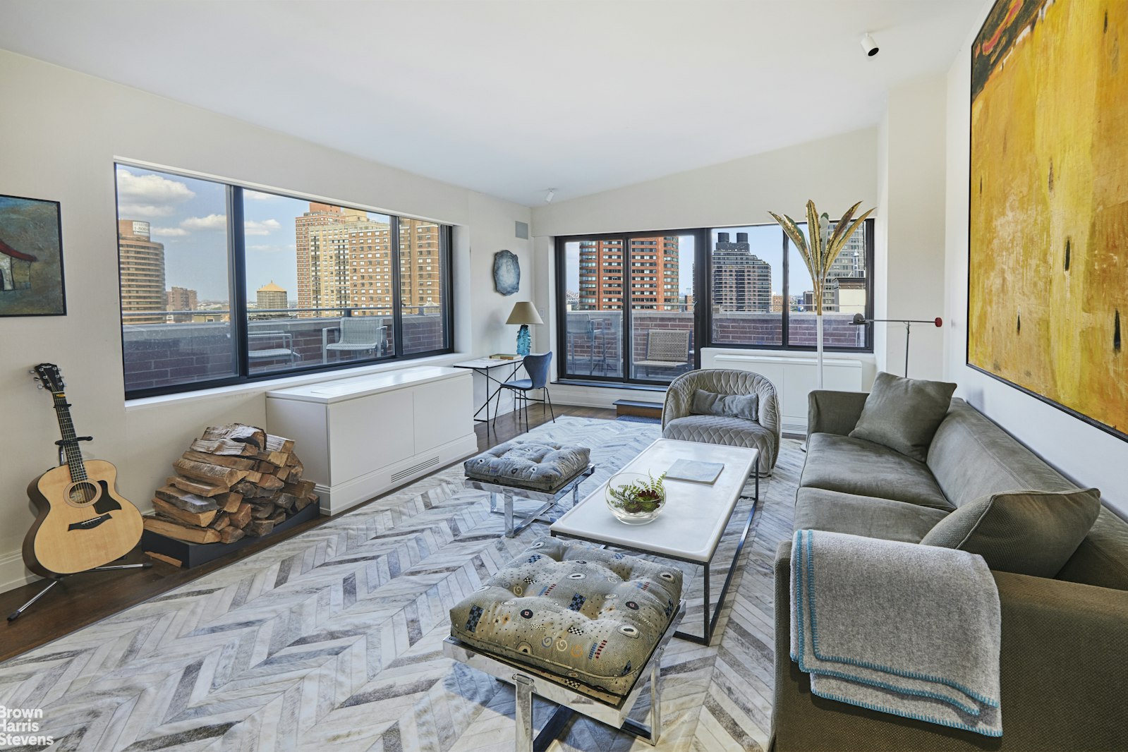 a living room with furniture and a floor to ceiling window