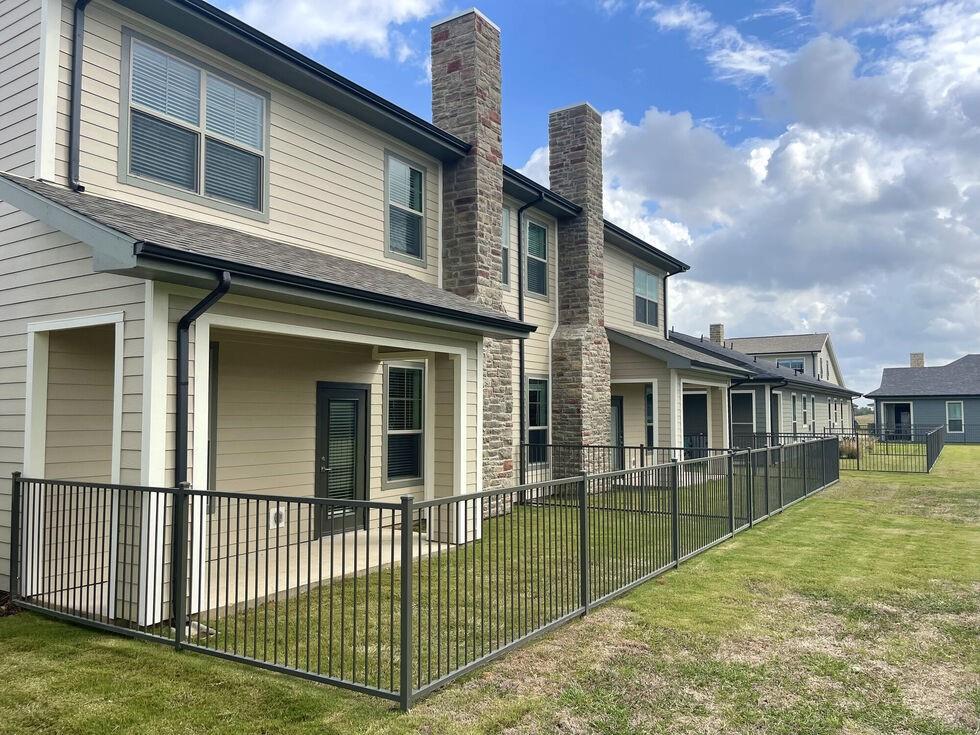 a view of a house with a backyard