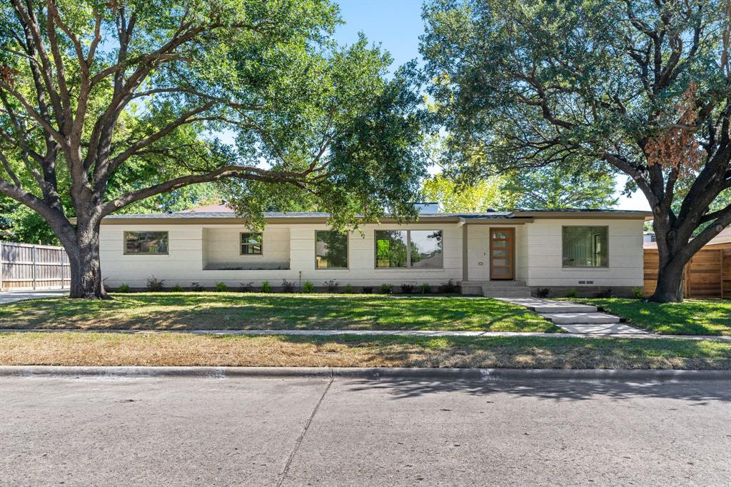 a front view of a house with a yard and a garage