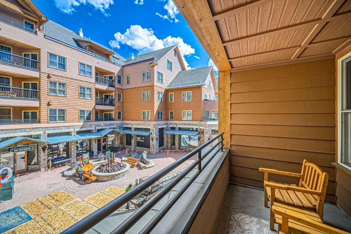 a view of a patio with couches chairs and wooden floor