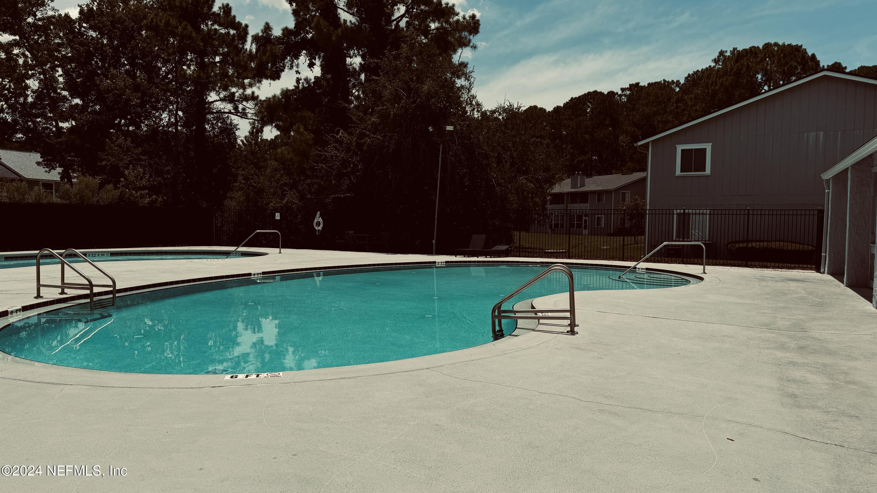 an outdoor space with swimming pool having outdoor seating