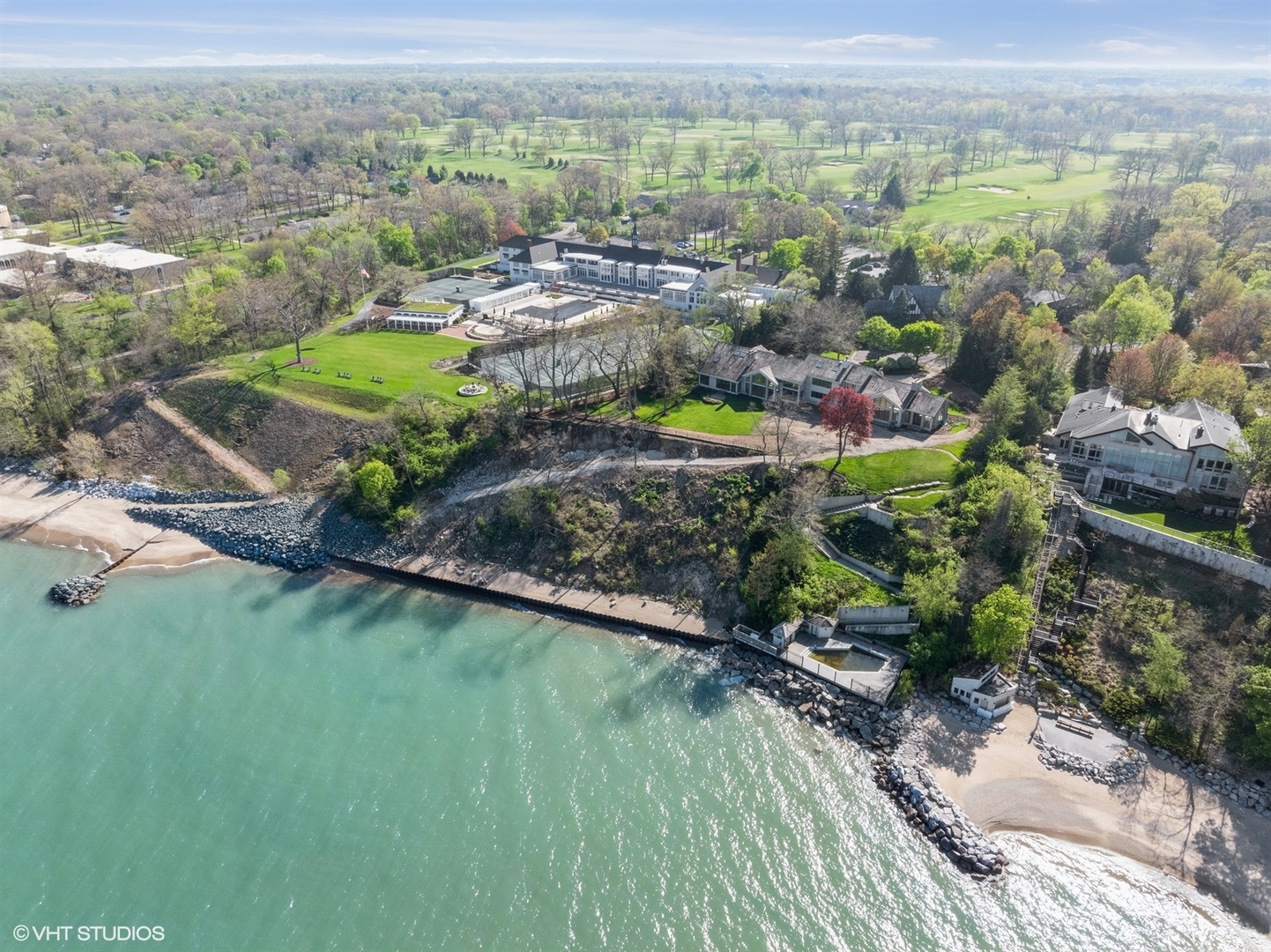 an aerial view of a house with a garden and lake view