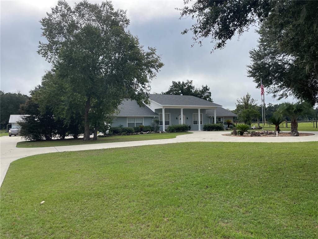 a front view of house with yard and outdoor seating