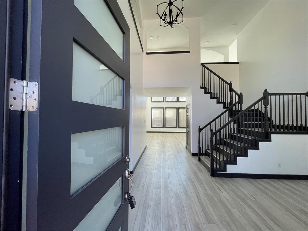 a view of entryway and hall with wooden floor