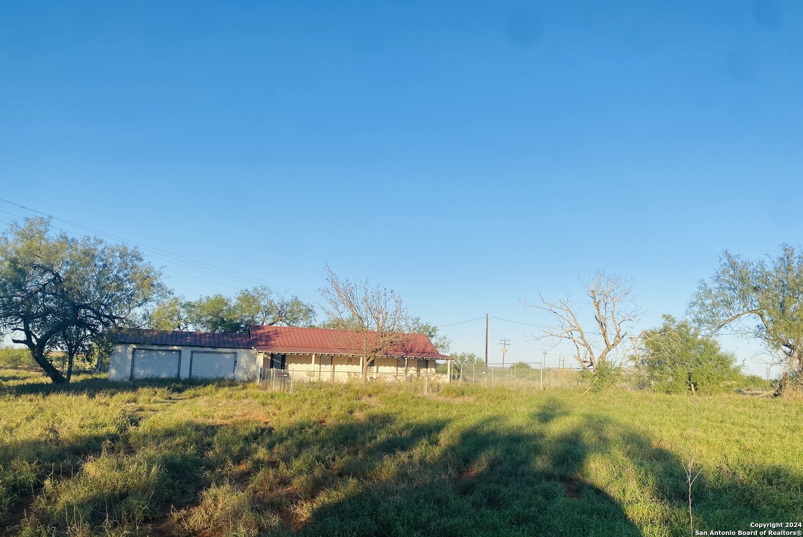 a view of backyard of house with green space