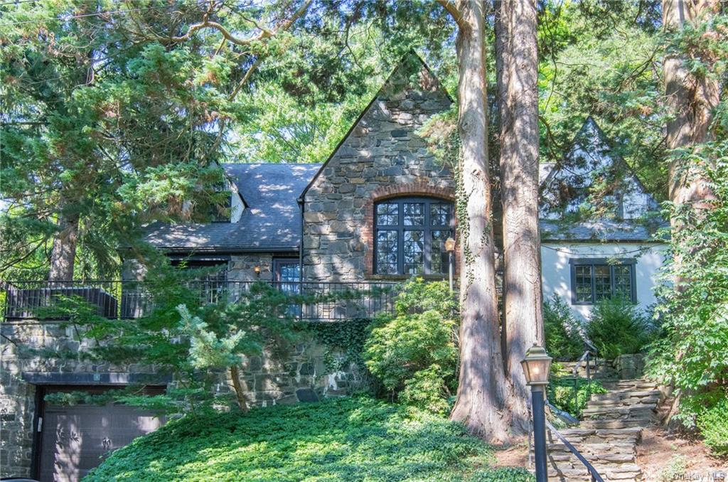 front view of a house with a tree