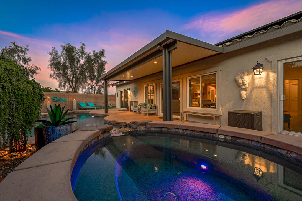 a swimming pool with outdoor seating and yard