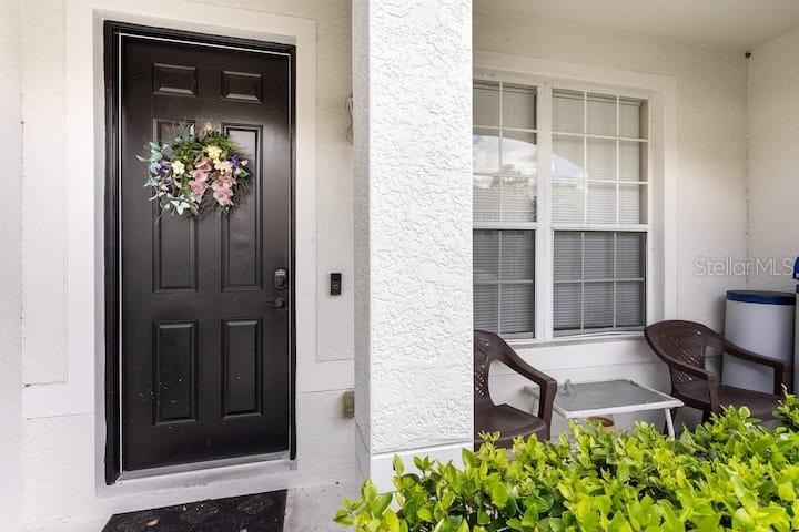 view of front door with wooden door