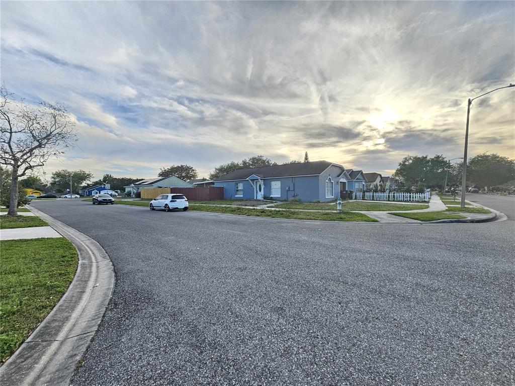 a view of a street with a big yard