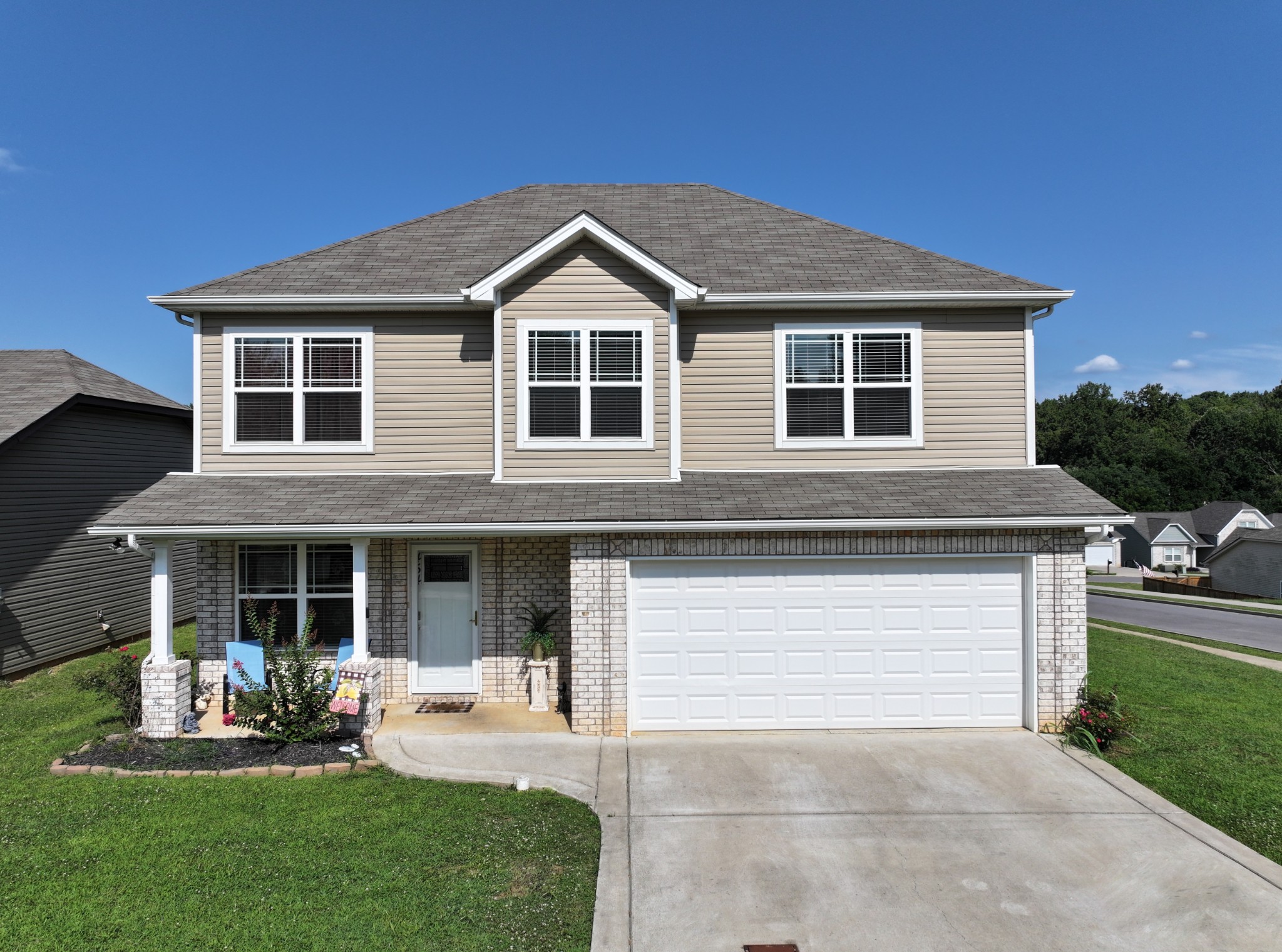 a front view of a house with a yard and porch