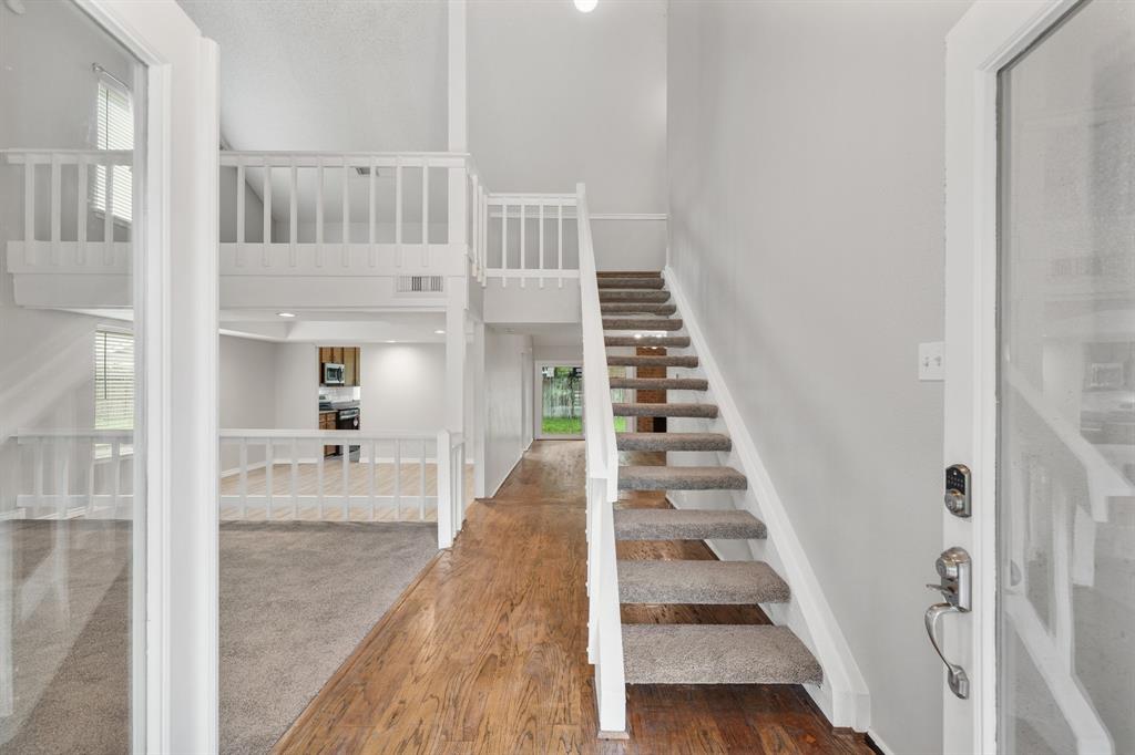 a view of entryway and hall with wooden floor