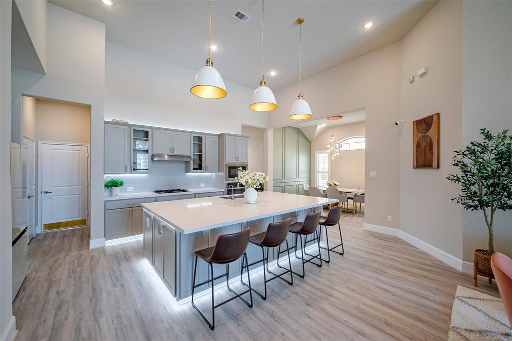 a large kitchen with a table and chairs