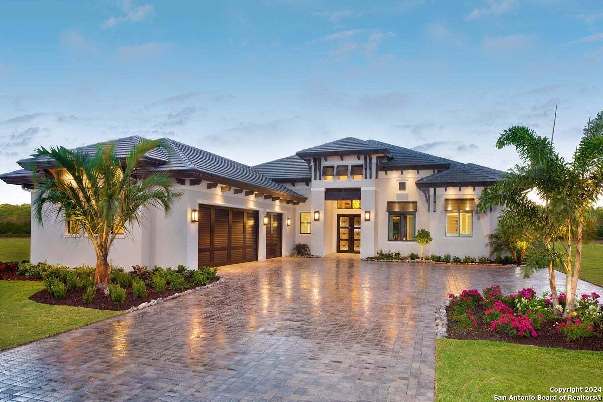 a front view of a house with garden