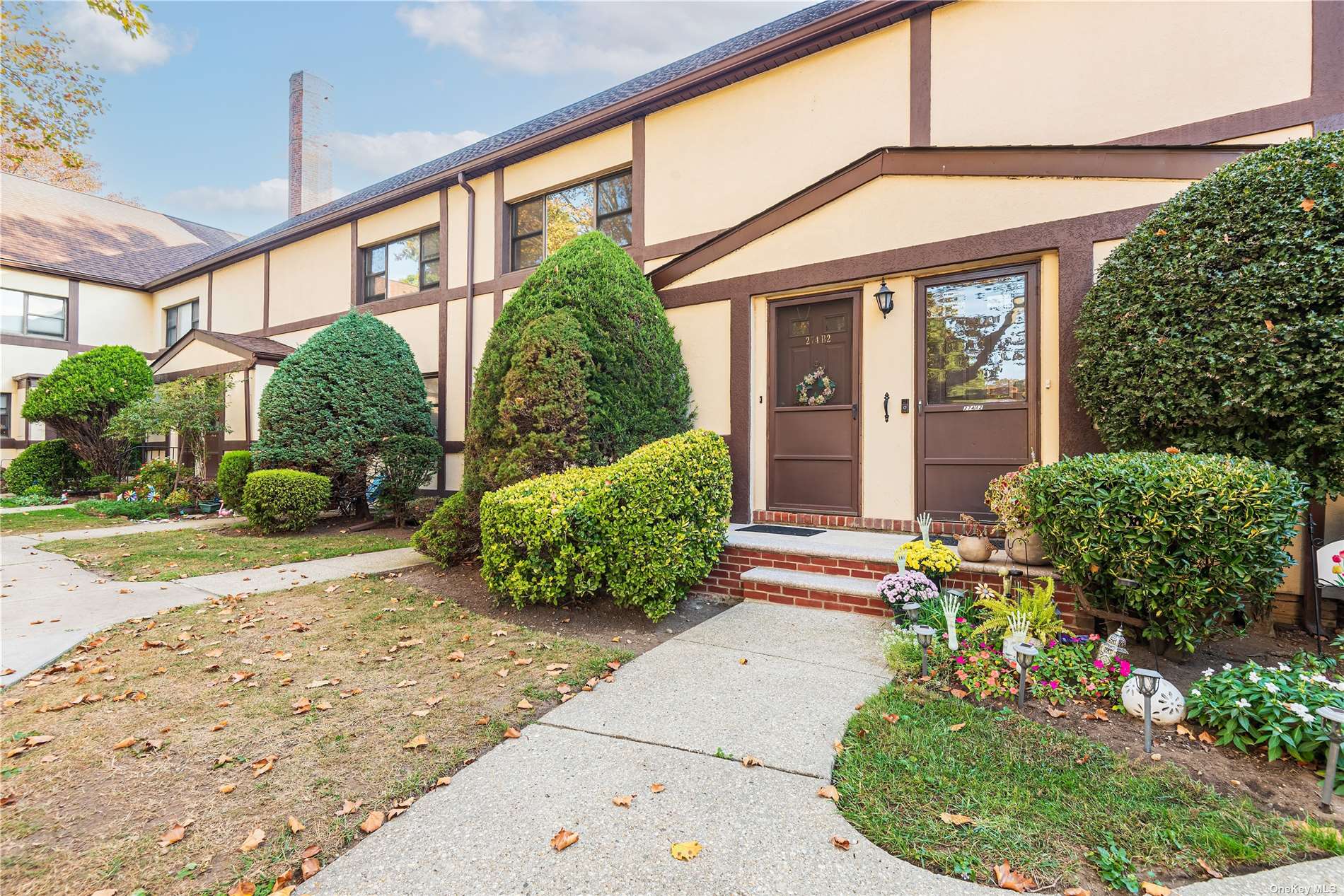 a front view of a house with garden