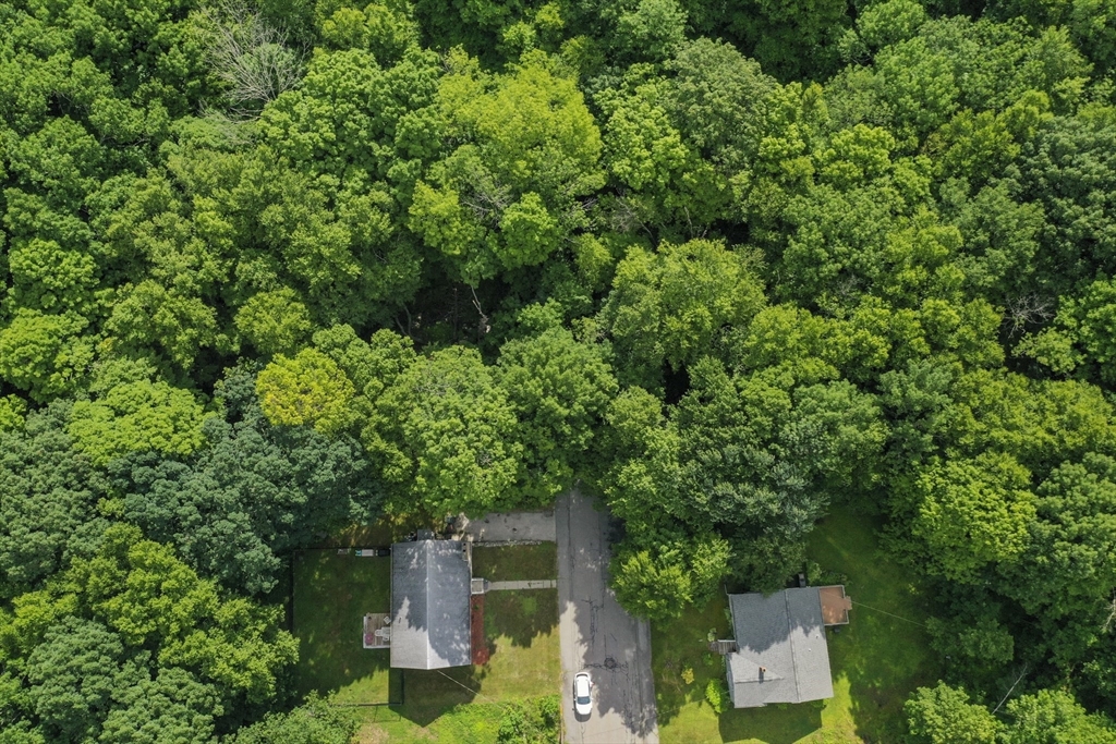 an aerial view of a house with yard