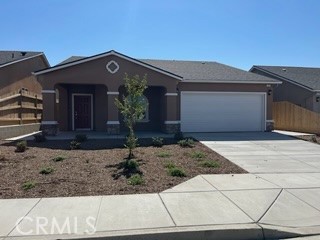 a front view of a house with garage and yard