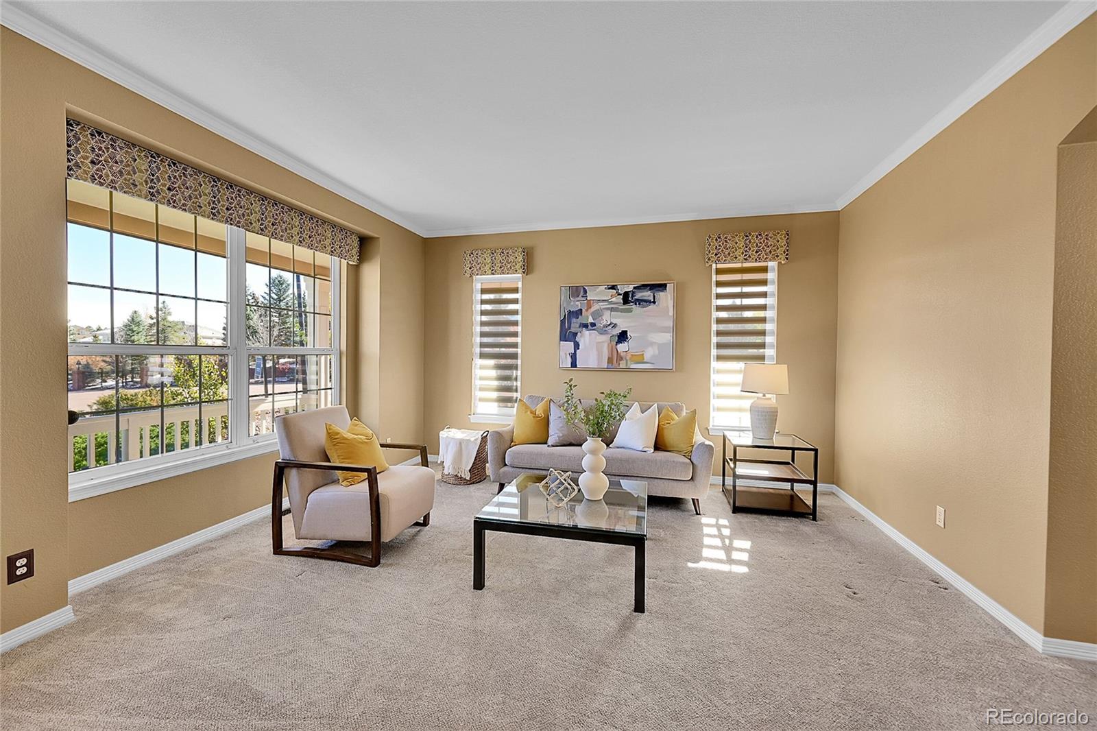 a living room with furniture and a floor to ceiling window