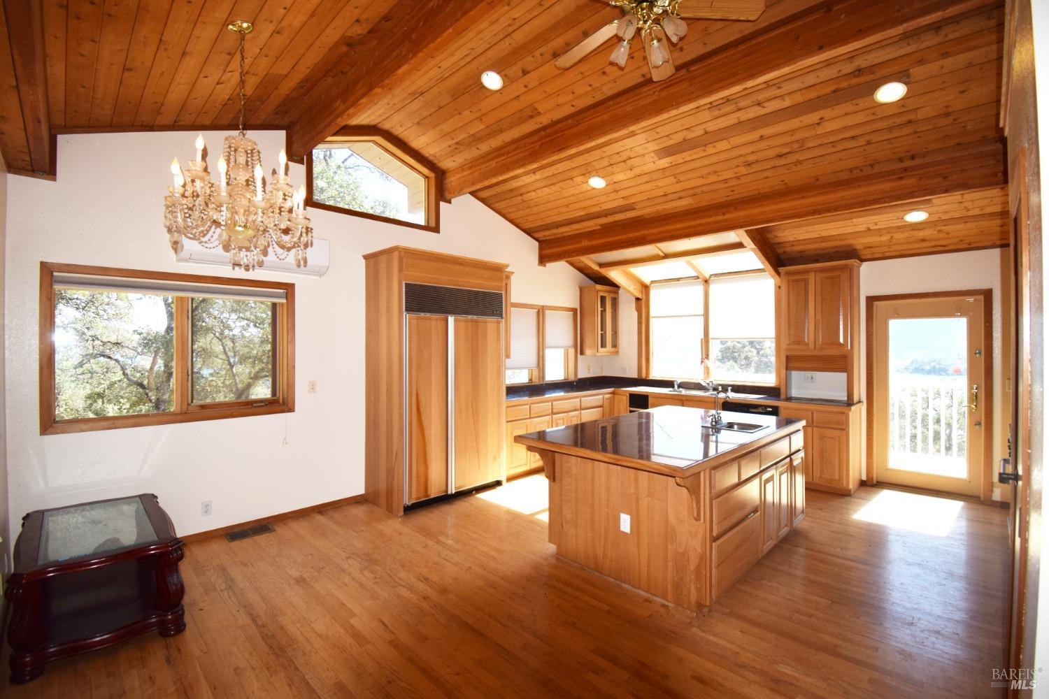 a kitchen with stove and wooden floor