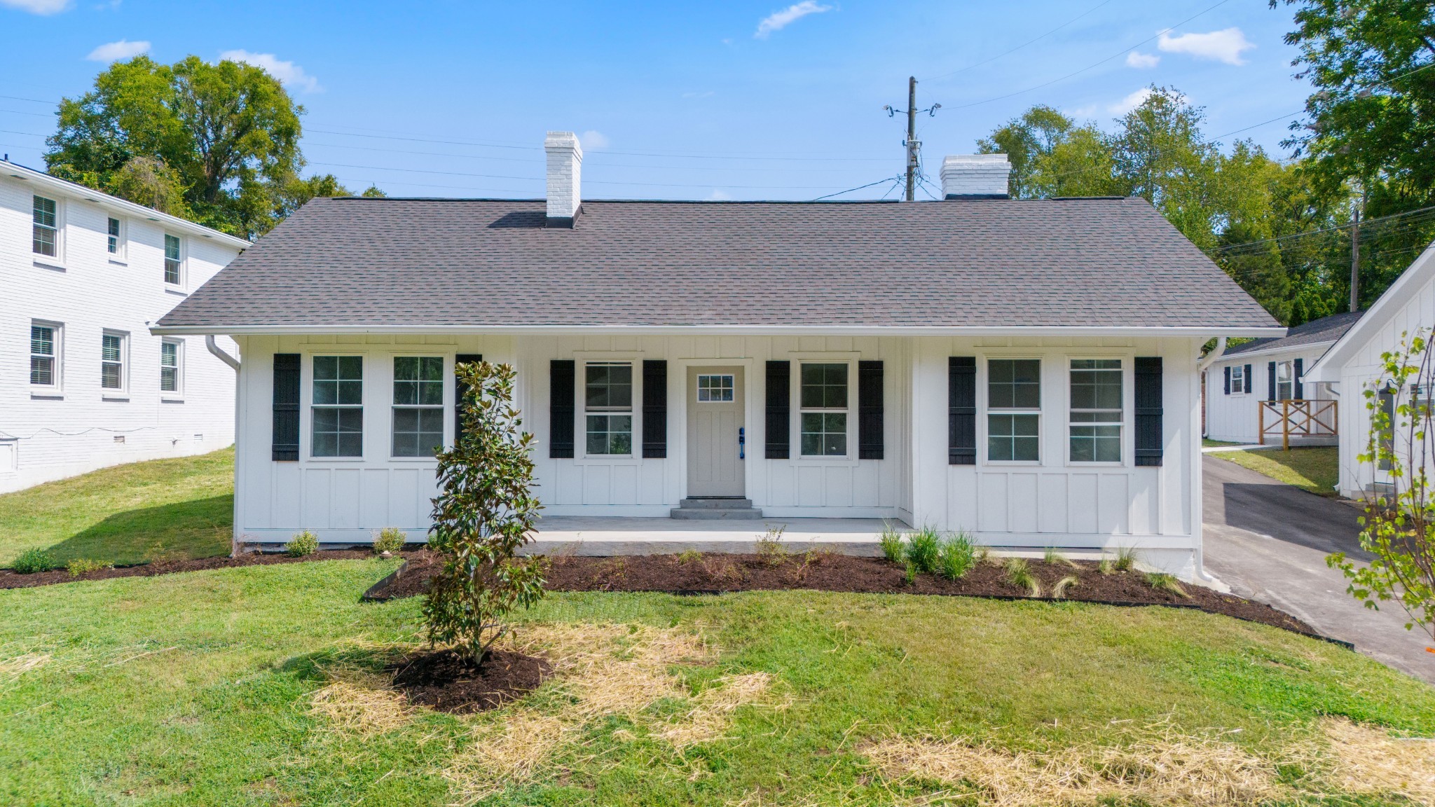 a front view of house with yard and outdoor seating