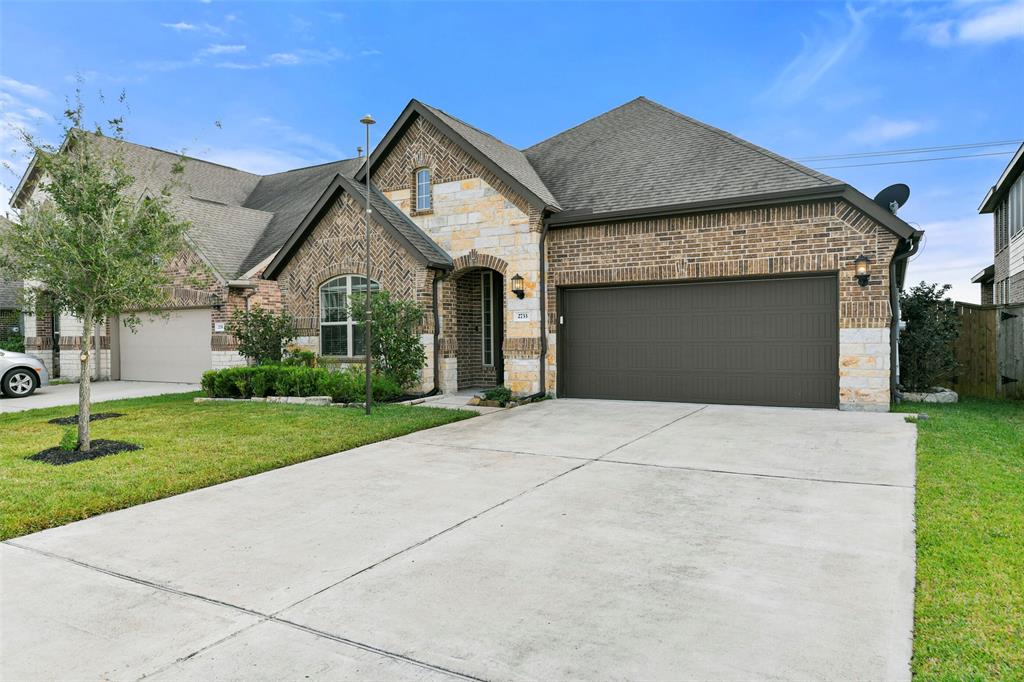 a front view of a house with a yard and garage