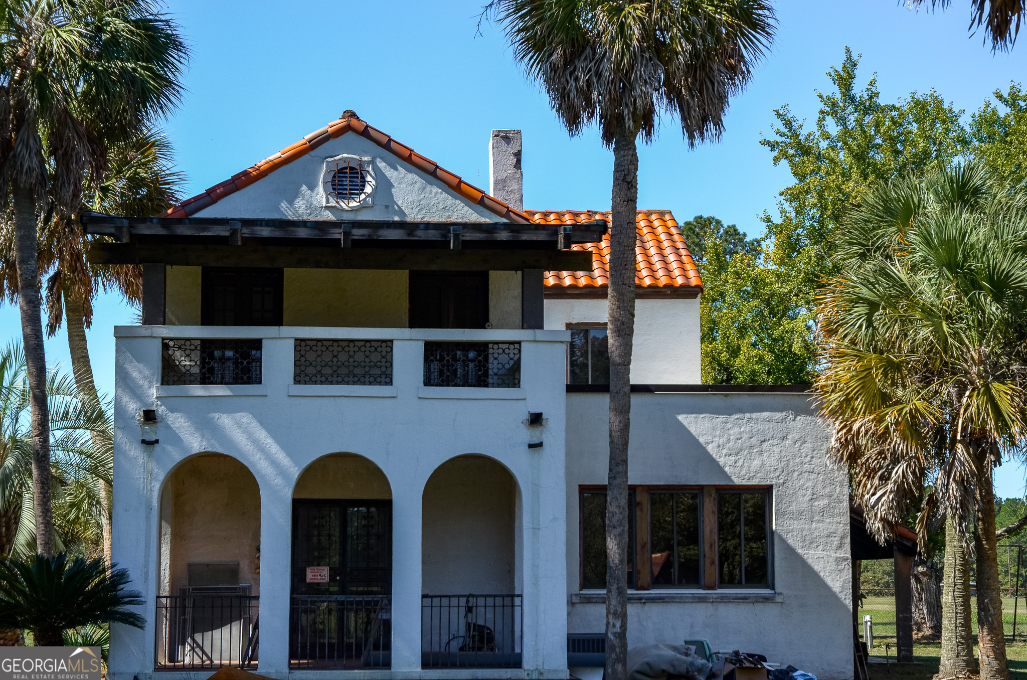 a front view of a house with plants