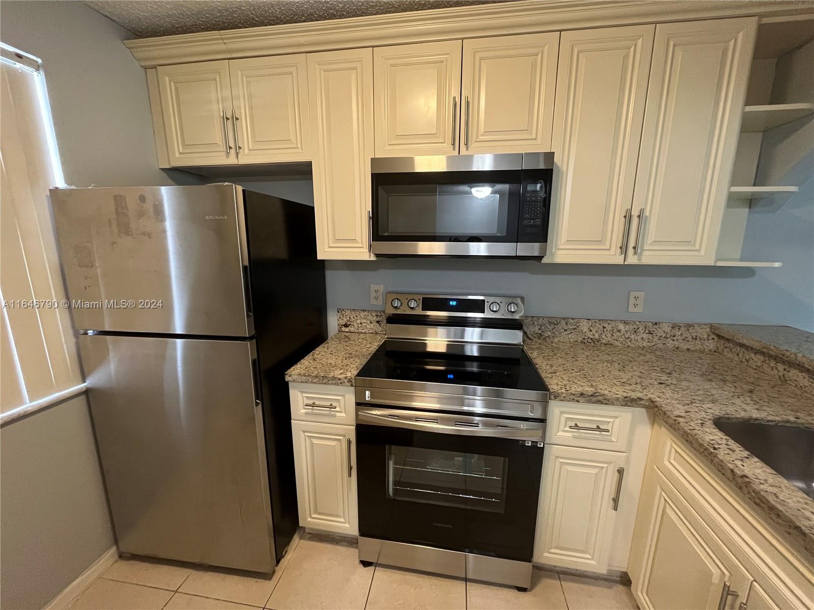 a kitchen with a stove microwave and refrigerator