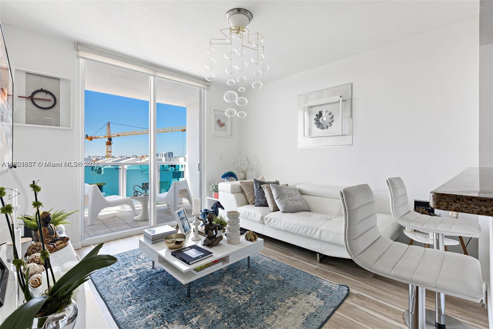 a living room with furniture and a chandelier