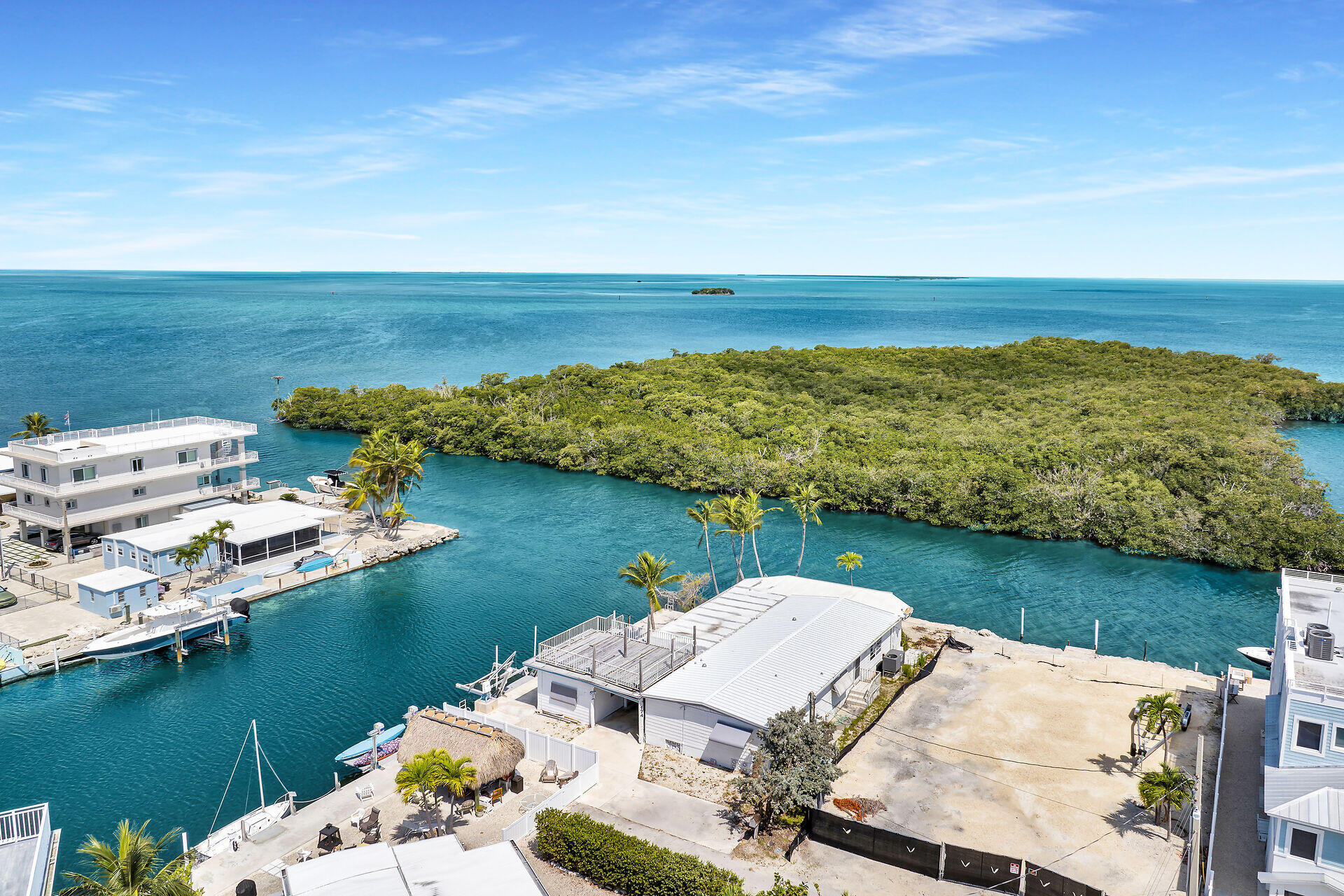 an aerial view of a houses with ocean view