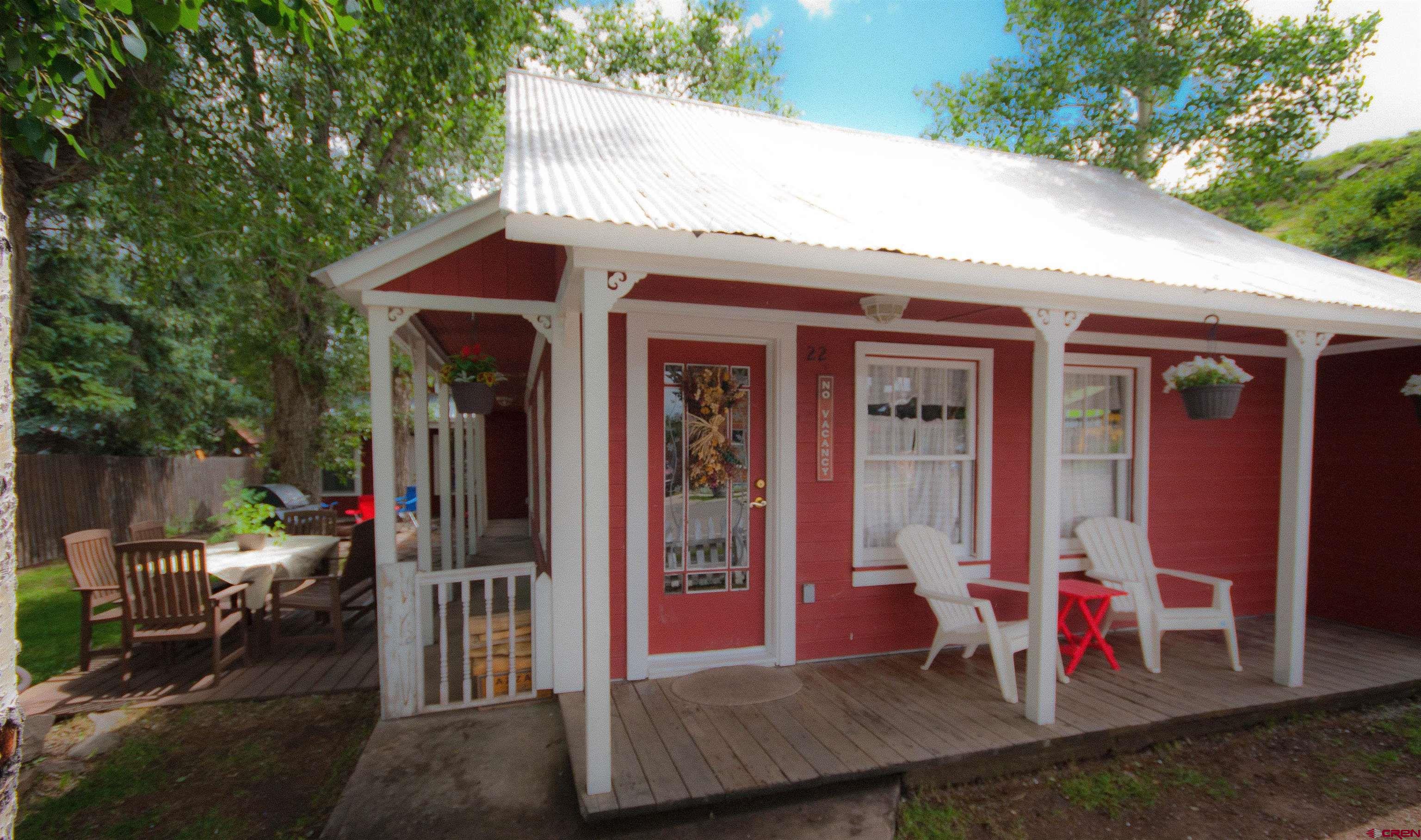 a view of small house with wooden deck