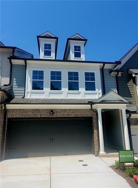 a front view of a house with garage