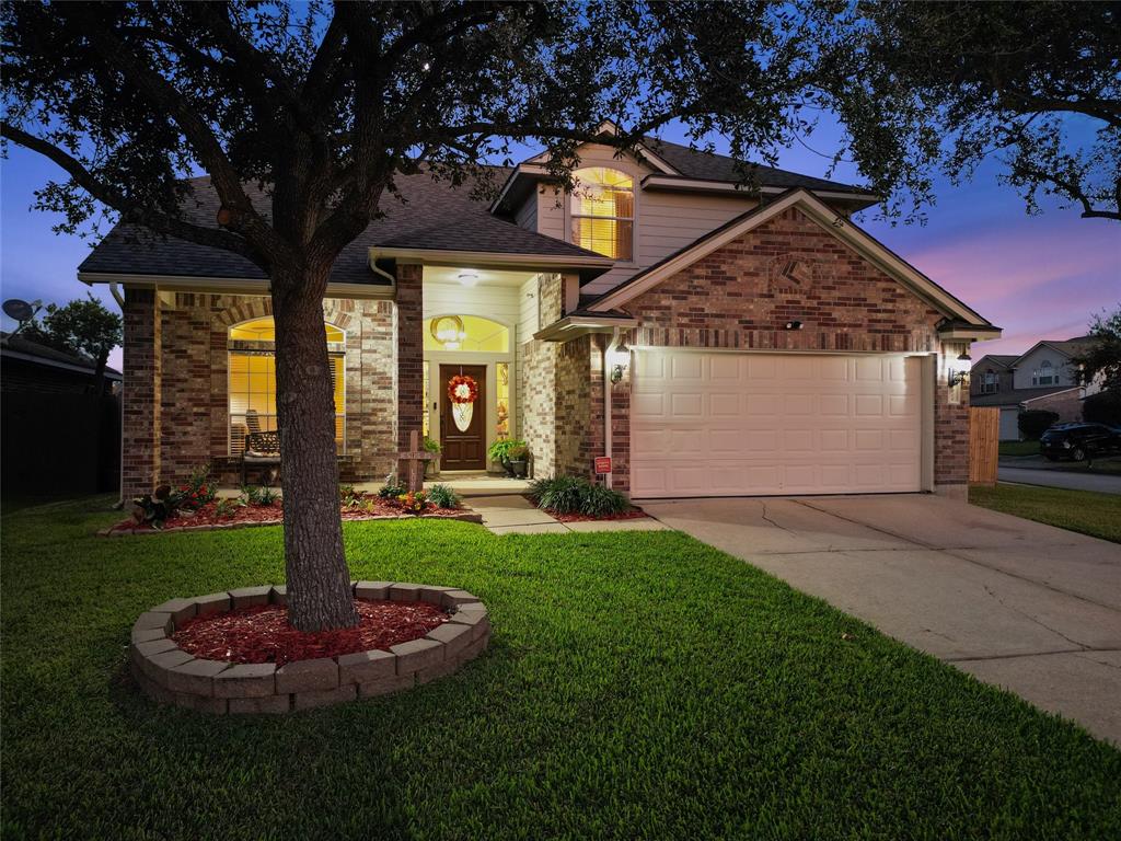 a front view of a house with a porch and a yard