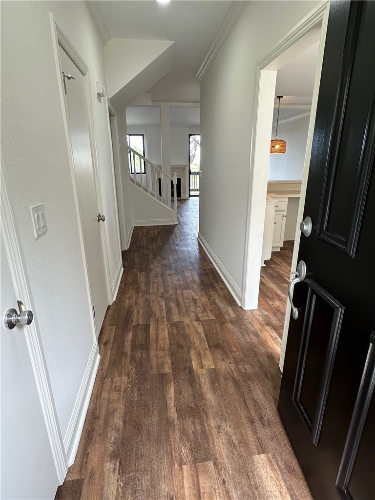 a view of a hallway view with wooden floor and staircase