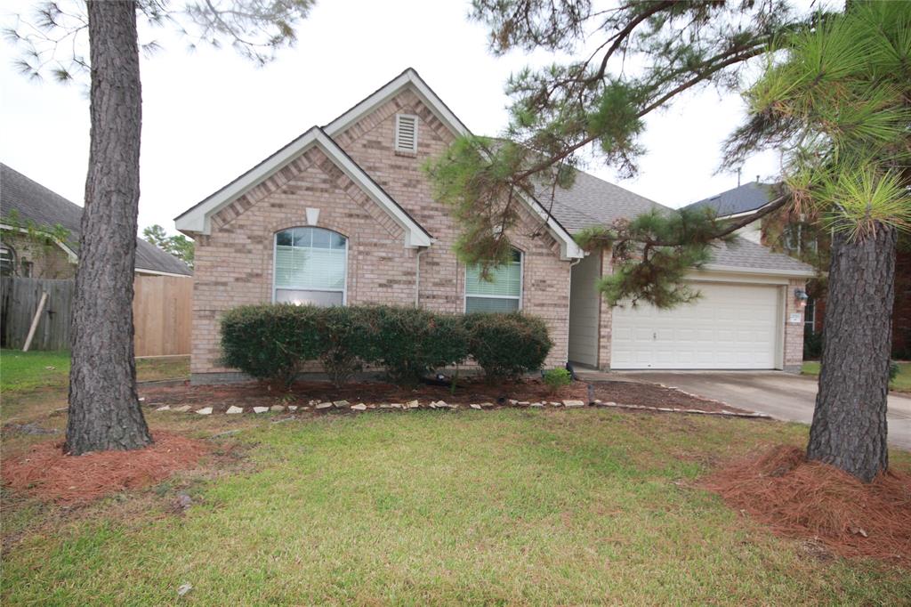 a view of an house with backyard and tree