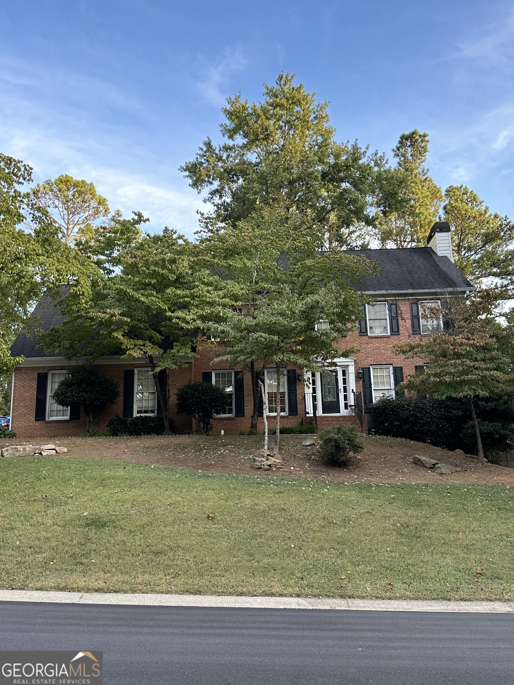 a front view of a house with garden