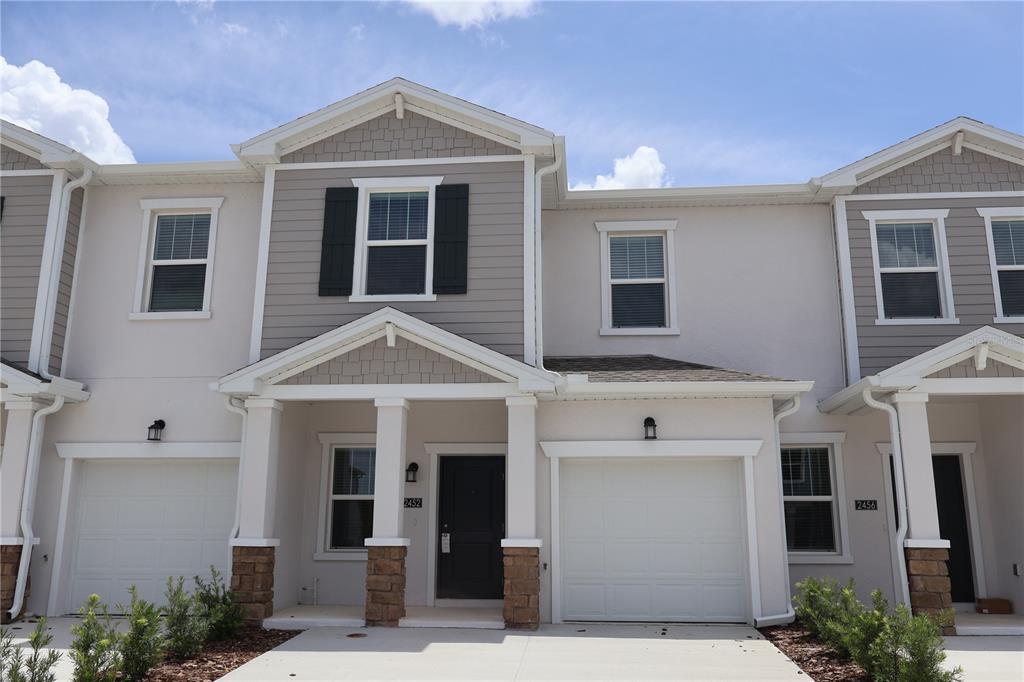 a front view of a house with a yard