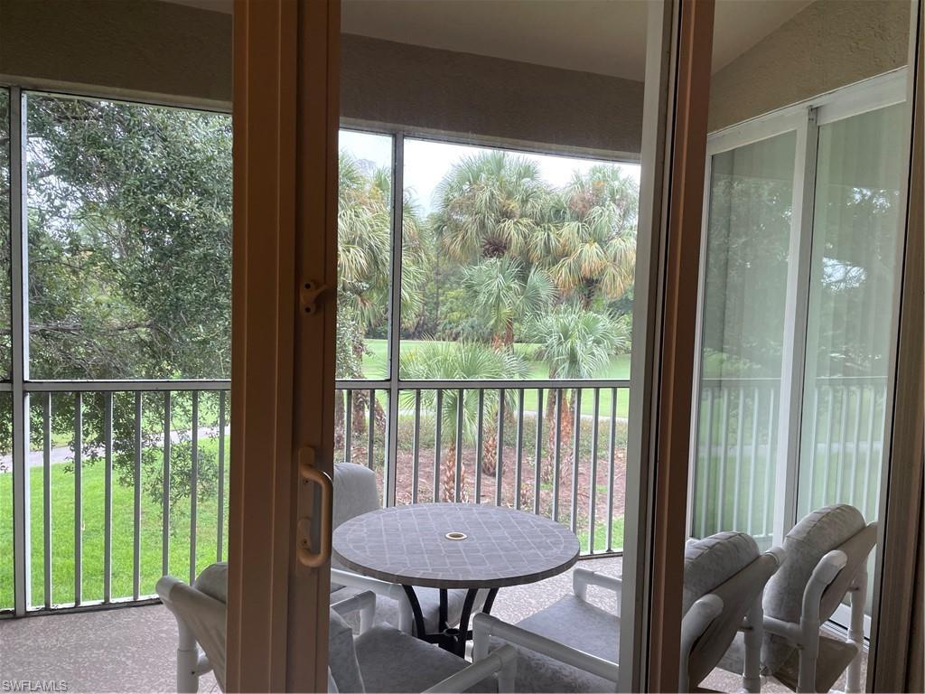 a view of a balcony with furniture and outside view