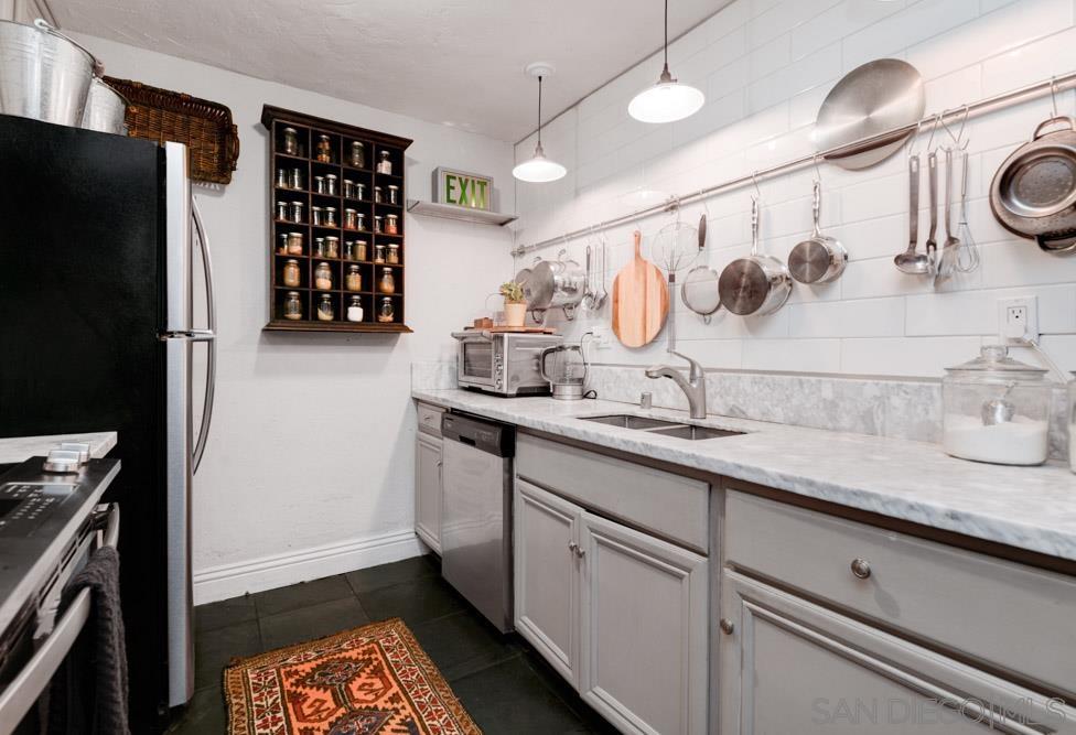 a kitchen with a refrigerator and a sink