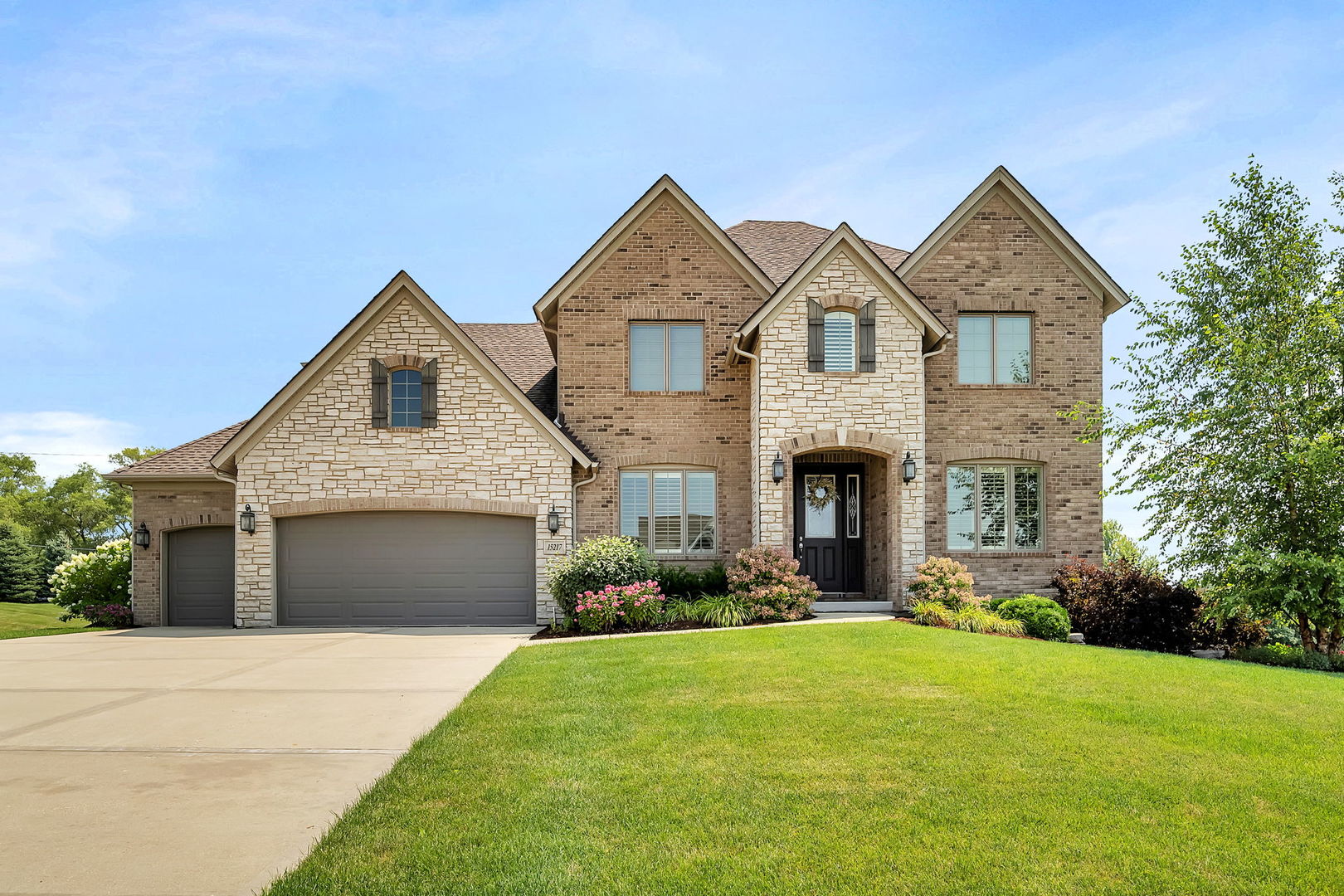 a front view of a house with a yard and garage