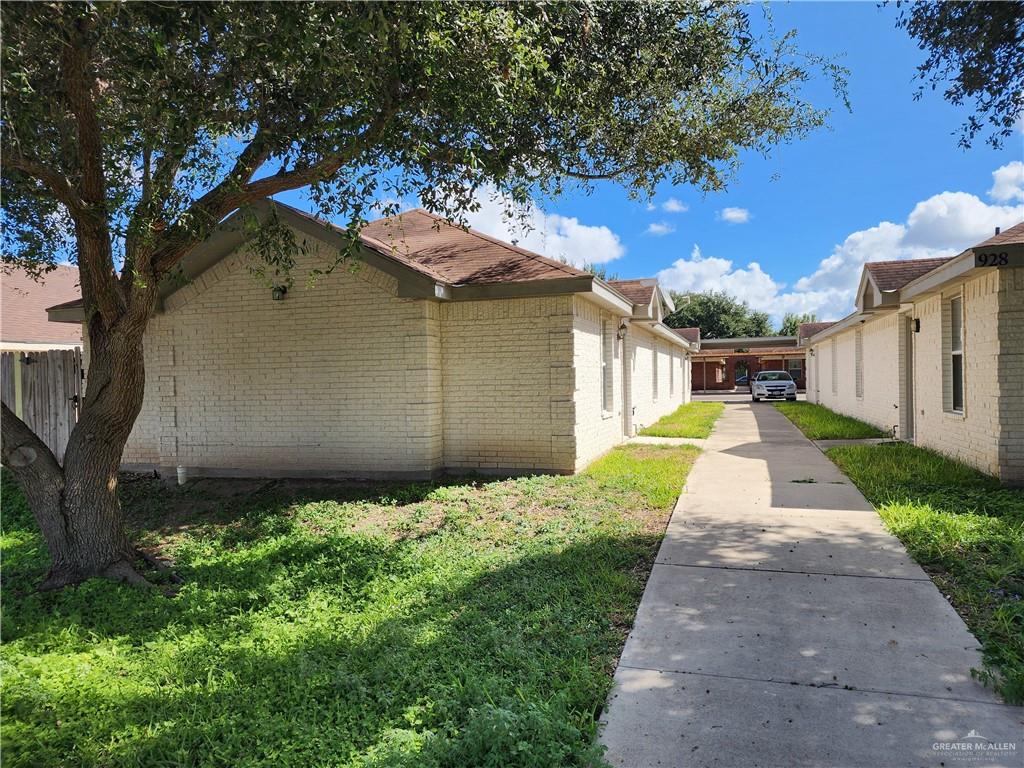 View of side of home featuring a yard