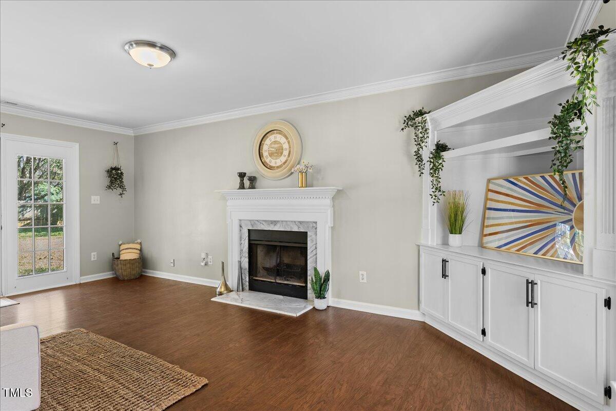 an empty room with windows and fireplace