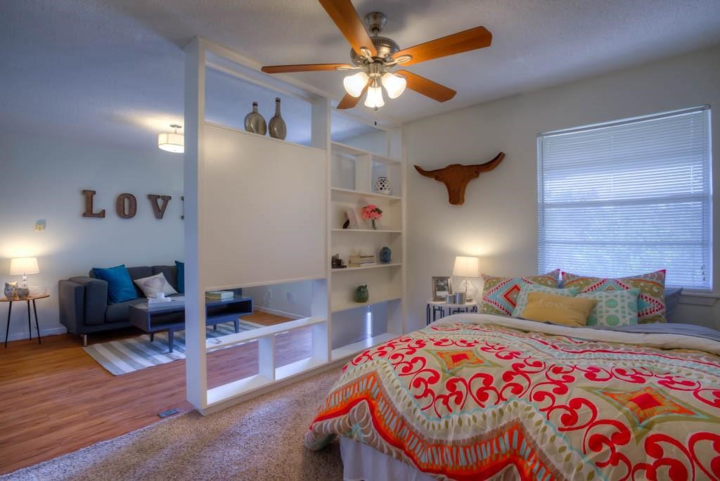 a bedroom with furniture and a chandelier