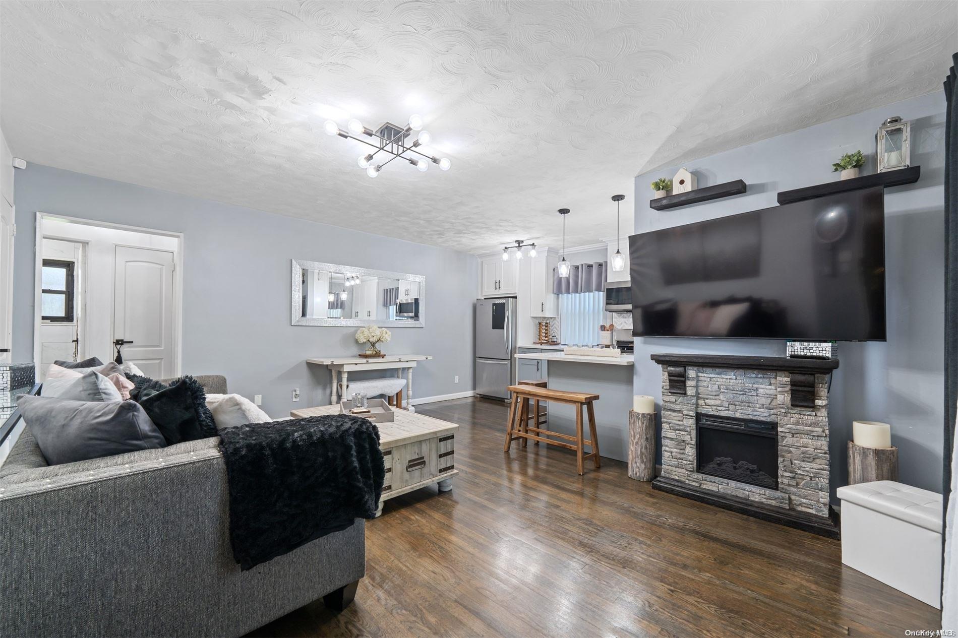 a living room with furniture a flat screen tv and a fireplace