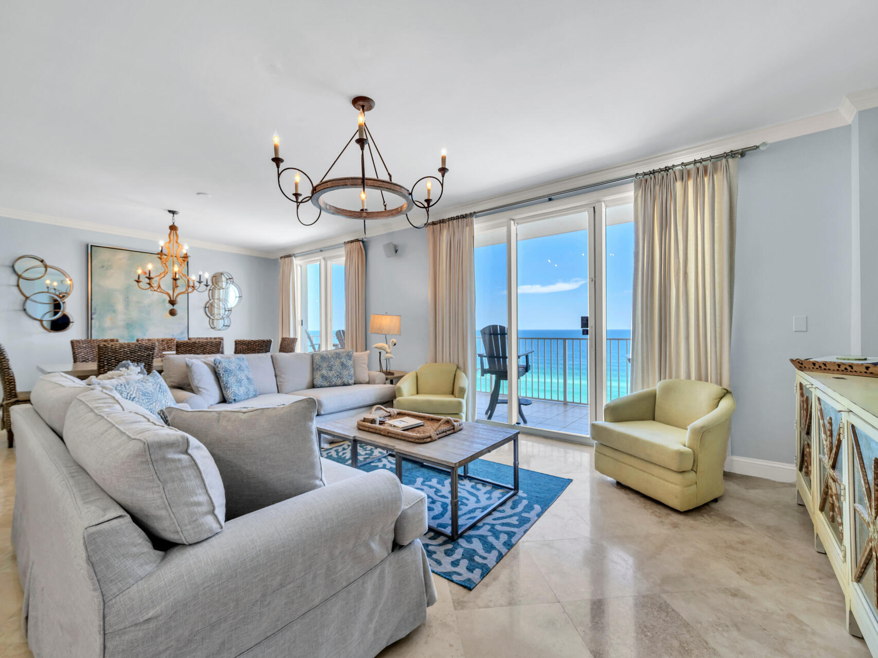 a living room with furniture and a chandelier