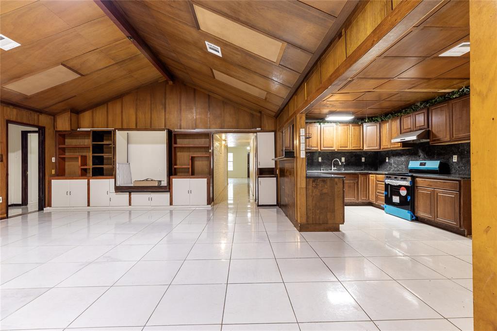 a view of kitchen with furniture and refrigerator